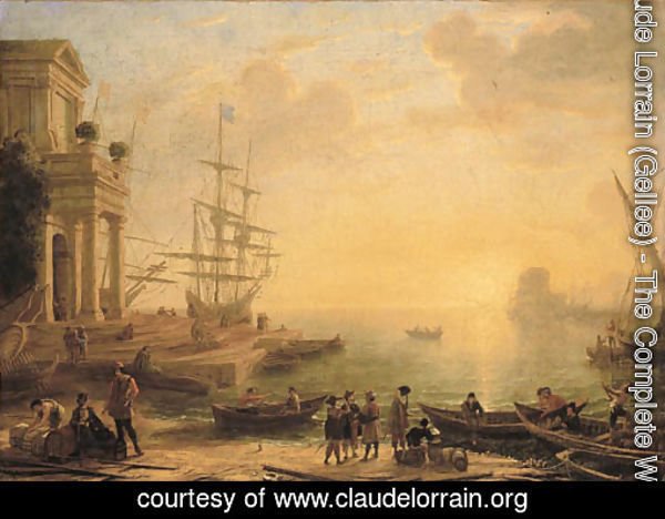 A capriccio of an Italianate harbour at sunset, with merchants, fishermen and stevedores on the shore in the foreground, men-o'-war at a quay beyond